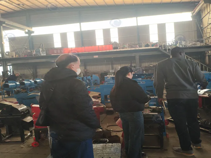 Ugandan Customer Viewing Corn Thresher With Sales Representative